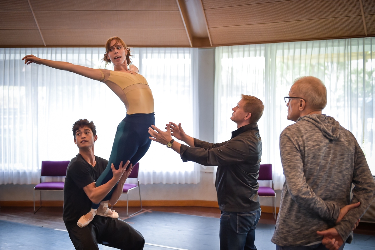Practicing the famous "Shrew" lift: Adhonay Soares da Silva and Elisa Badenes double check the position in the mirror, while Ballet Master Krzysztof Nowogrodzki spots Elisa to ensure she does not fall, and Reid Anderson observes the lift he himself danced so many times.