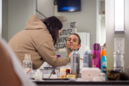 Make-up artist Lola Khurramova applies a beard to Roman Novitzky who will dance Tybalt